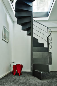 Empty chair by staircase at home