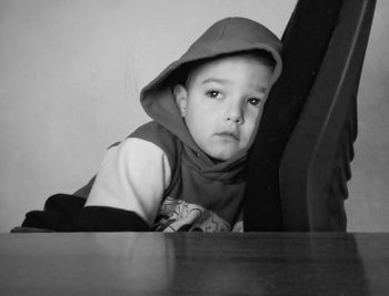 Cute boy looking away while sitting at home