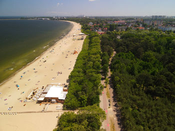 High angle view of cityscape and sea against sky