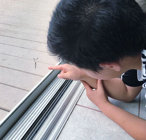 High angle portrait of boy holding camera