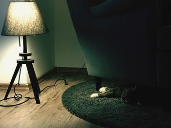 Illuminated electric lamp on table at home