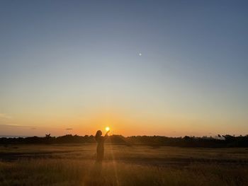 Scenic view of field against sky during sunset