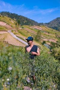 Man on field against mountain