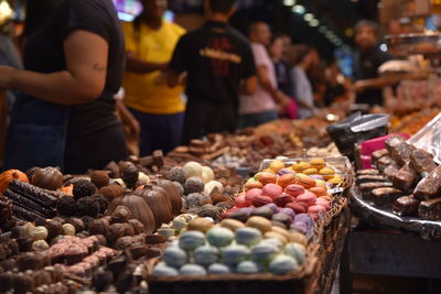 People for sale at market stall