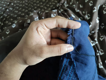 Close-up of hand holding clothing