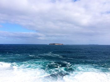 Scenic view of sea against cloudy sky