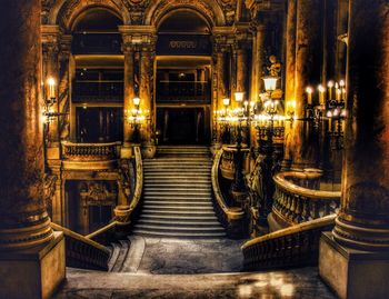 Illuminated staircase of historic building at night