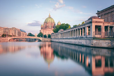 Berlin cathedral in city by spree river against sky