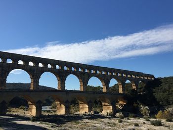 Arch bridge against blue sky