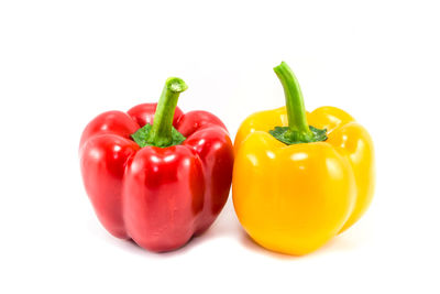 Close-up of red bell peppers against white background