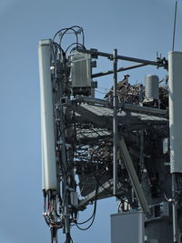 Low angle view of communications tower against sky