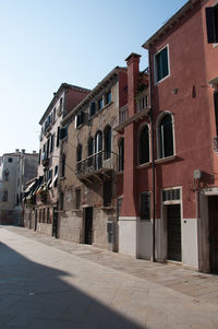 Street amidst buildings against sky