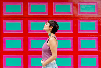 Rear view of woman standing against blue sky