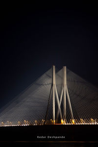 Low angle view of suspension bridge against sky