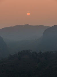 Scenic view of silhouette mountains against sky during sunset