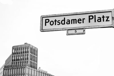 Low angle view of information sign against clear sky