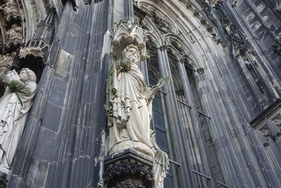 Low angle view of statue against sky at temple