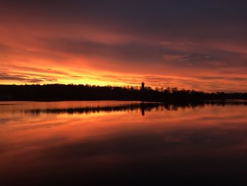 Scenic view of lake against romantic sky at sunset