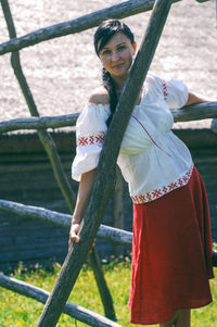 Rear view of woman holding railing