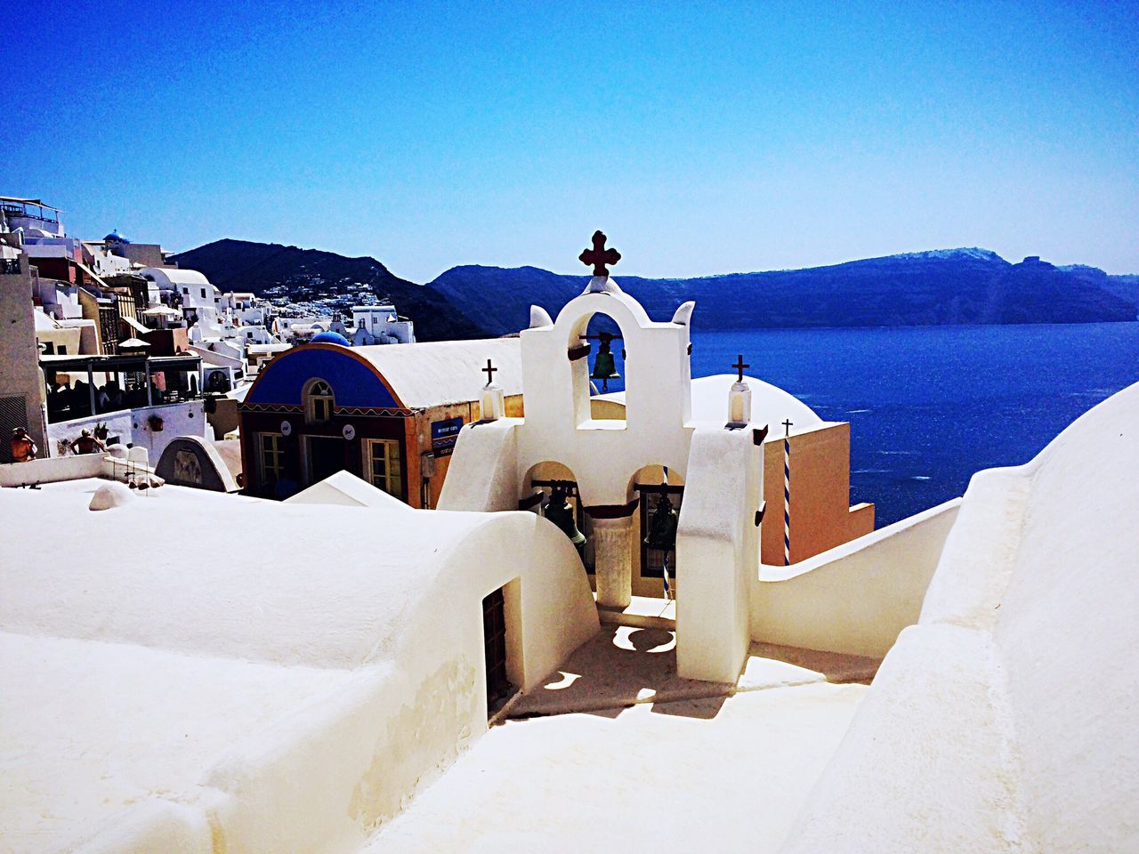 mountain, whitewashed, religion, white color, built structure, outdoors, spirituality, day, building exterior, travel destinations, architecture, no people, nature, place of worship, mountain range, sky, clear sky, sea, snow