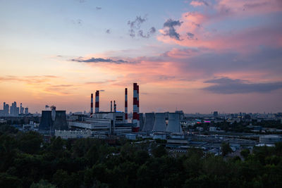 Buildings in city against sky during sunset