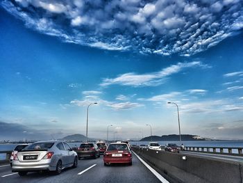 View of highway against cloudy sky