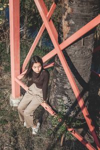 High angle portrait of woman standing by railing