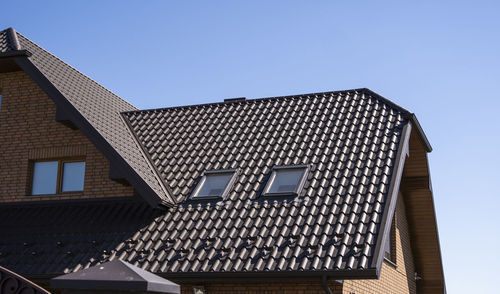 Low angle view of building against clear blue sky