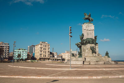 Statue of historic building against sky