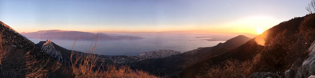 Panoramic view of snowcapped mountains against sky during sunset