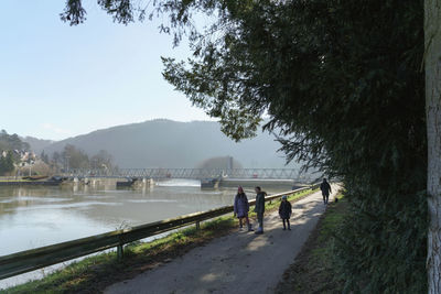 People walking on country road 