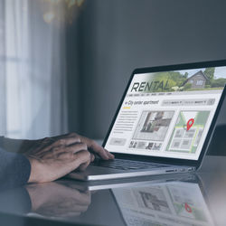 Midsection of man using laptop at home