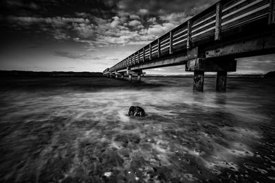 Bridge over sea against sky