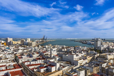 High angle view of buildings and sea against sky