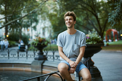 Portrait of young man sitting on bicycle