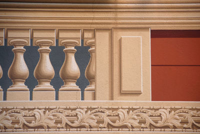 Close-up of carvings on railing against building