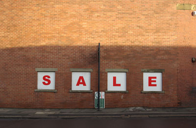 Sale sign on brick wall