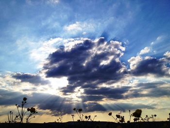 Low angle view of landscape against cloudy sky