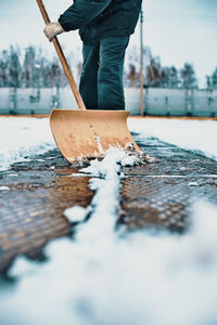 Low section of man working on snow