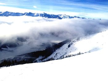 Scenic view of snow covered mountains against sky