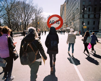 People walking on road in city