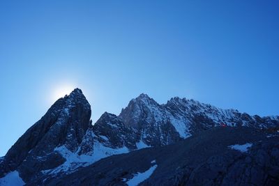 Scenic view of snowcapped mountains against clear blue sky