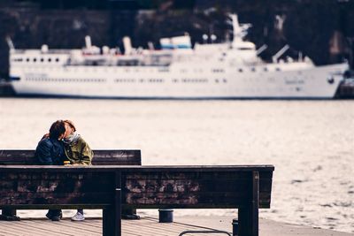 Rear view of woman sitting on bench