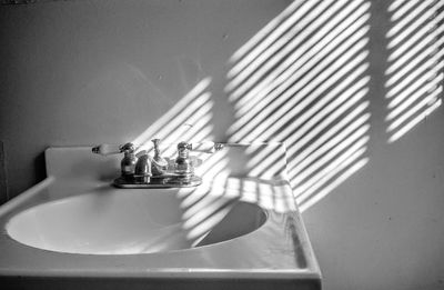 Sunlight on wall by sink in bathroom