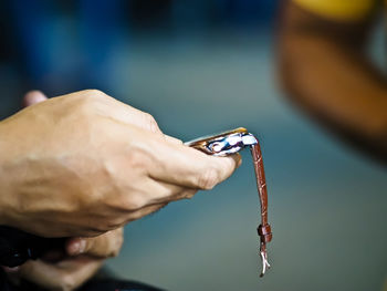 Close-up of hand holding wristwatch