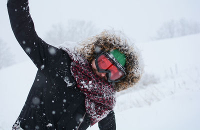 Boy in snow against sky