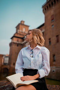 Woman standing by building