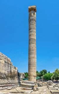 Low angle view of old ruins against clear blue sky