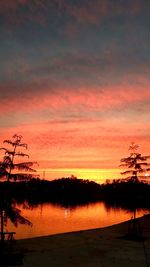 Scenic view of lake against romantic sky at sunset