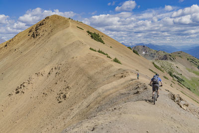 Man on sand against sky